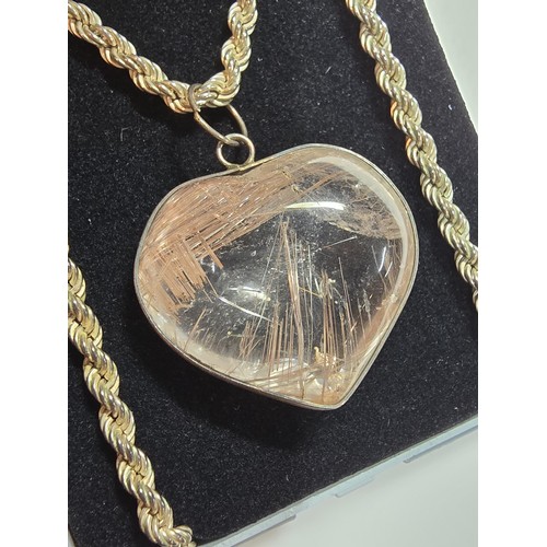 228 - An impressive 925 silver rutilated quartz heart formed pendant set on a good chunky 20