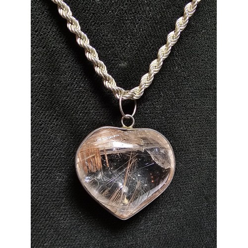 228 - An impressive 925 silver rutilated quartz heart formed pendant set on a good chunky 20