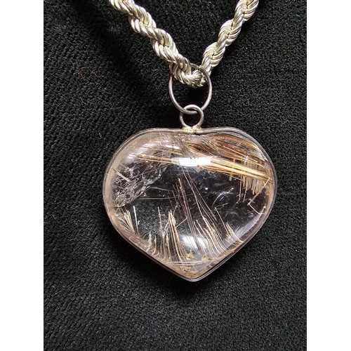 228 - An impressive 925 silver rutilated quartz heart formed pendant set on a good chunky 20