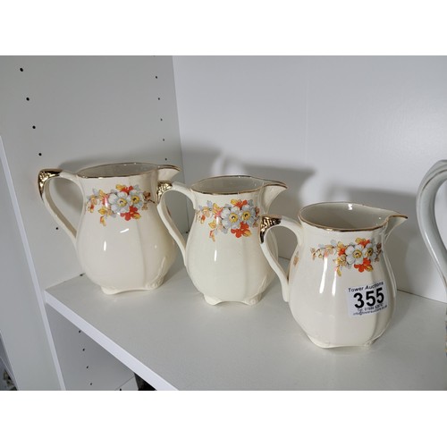 355 - 3 x Graduated jugs 1930's by Alfred Meakin Marigold marquis and 3 further graduated jugs un signed