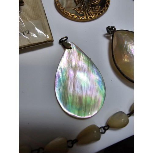 232 - A collection of good quality mother of pearl jewellery to include 3 good mother of pearl pendants wi... 