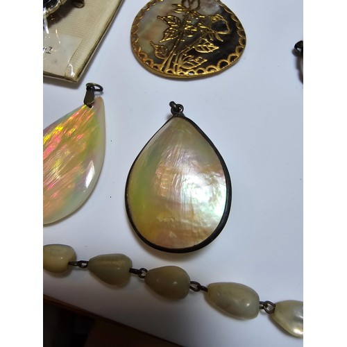 232 - A collection of good quality mother of pearl jewellery to include 3 good mother of pearl pendants wi... 