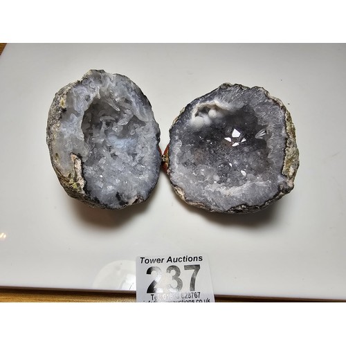 237 - A split natural geode presenting pretty crystal formations inside, both pieces have been hinged to o... 