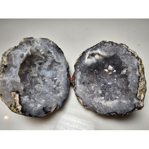 237 - A split natural geode presenting pretty crystal formations inside, both pieces have been hinged to o... 