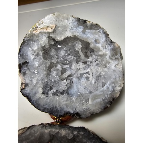 237 - A split natural geode presenting pretty crystal formations inside, both pieces have been hinged to o... 