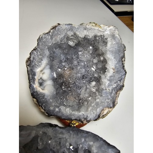 237 - A split natural geode presenting pretty crystal formations inside, both pieces have been hinged to o... 