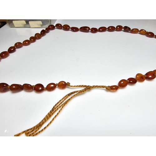 241 - A good quality vintage hand knotted genuine amber beaded necklace, each bead has an interesting natu... 