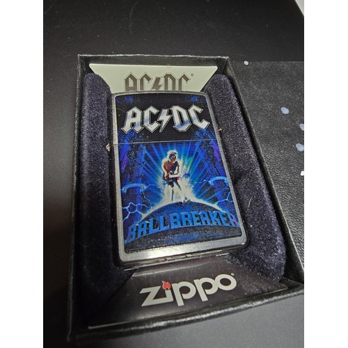 246 - A Cased Zippo lighter with AC/DC Ballbreaker to the front along with a Kantai Michael Jackson lighte... 