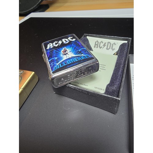 246 - A Cased Zippo lighter with AC/DC Ballbreaker to the front along with a Kantai Michael Jackson lighte... 