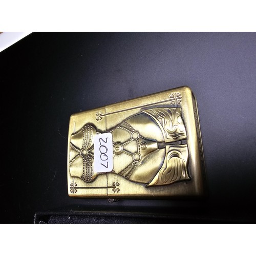 247 - A pair of Kantai brushed brass petrol lighters with bikini dressed women as the design. 1 lighter is... 