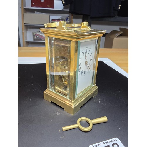 252 - A good vintage brass case carriage clock with an enamel dial, featuring bevel edged glass to the fro... 