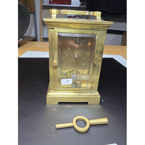 252 - A good vintage brass case carriage clock with an enamel dial, featuring bevel edged glass to the fro... 