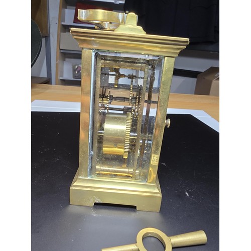 252 - A good vintage brass case carriage clock with an enamel dial, featuring bevel edged glass to the fro... 