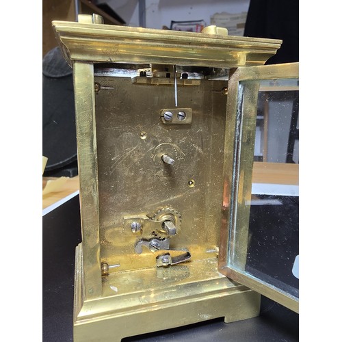 252 - A good vintage brass case carriage clock with an enamel dial, featuring bevel edged glass to the fro... 