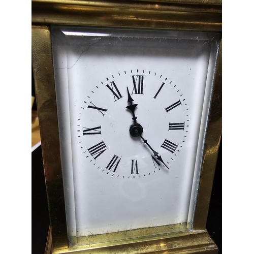 252 - A good vintage brass case carriage clock with an enamel dial, featuring bevel edged glass to the fro... 