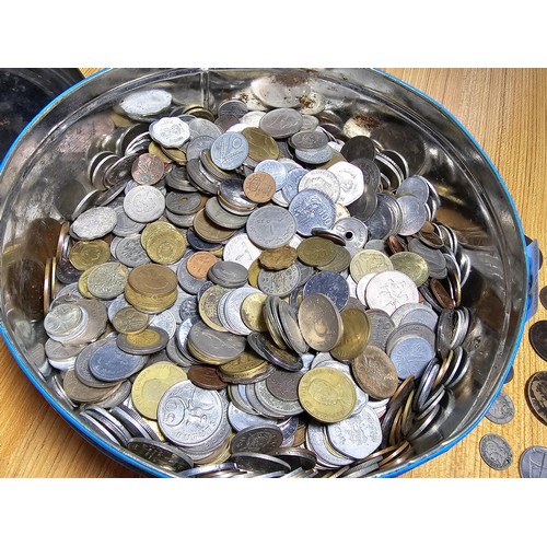 263 - A very large quantity of various vintage and antique world coins in a metal tin, all unsorted and do... 