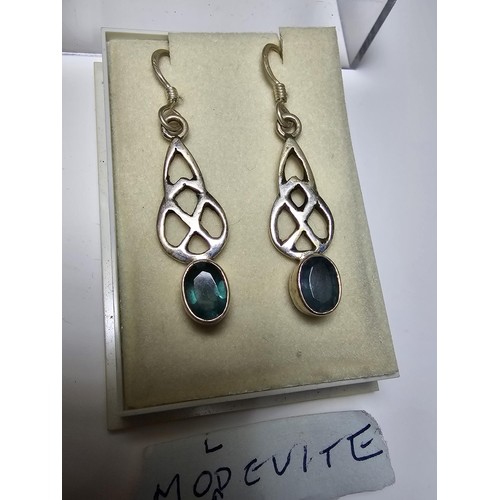 286 - A pair of 925 silver drop earrings inset with rare moldavite faceted gemstones. Moldavite is formed ... 