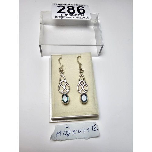 286 - A pair of 925 silver drop earrings inset with rare moldavite faceted gemstones. Moldavite is formed ... 