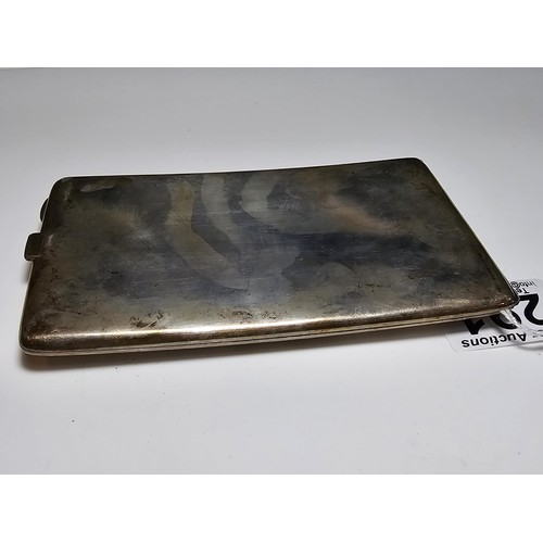 291 - A large solid silver shaped cigarette case featuring an engraved middle eastern design to the top fe... 