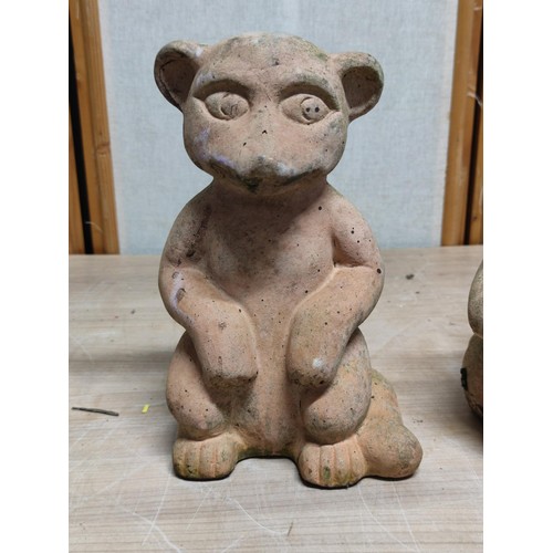 406 - A pair of weathered terracotta Meerkats both sitting down, tallest stands at 28cm high