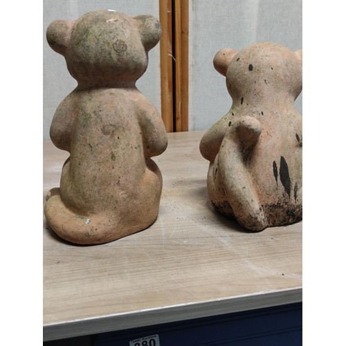 406 - A pair of weathered terracotta Meerkats both sitting down, tallest stands at 28cm high