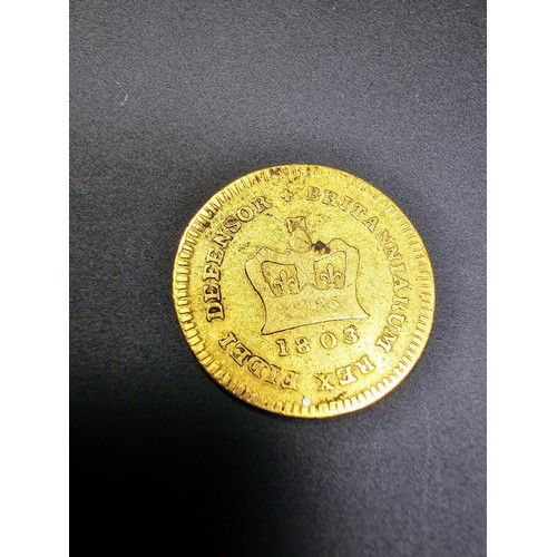 297 - An antique solid gold third guinea coin, George III, dated 1803, in good antique condition. Coin has... 