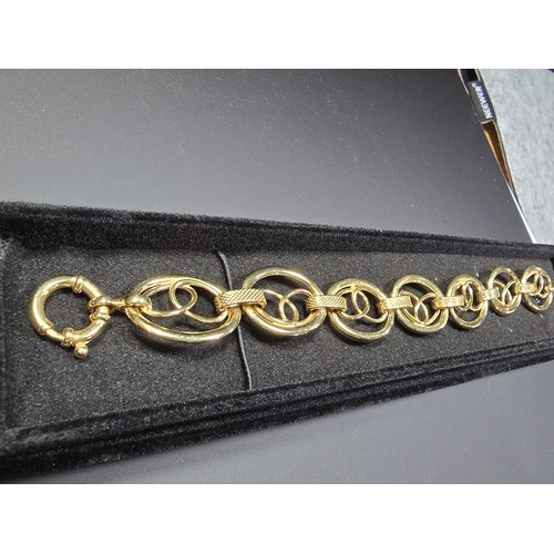 301 - A modern hallmarked 9ct yellow gold bracelet with an unusual multi loop design, in excellent clean c... 