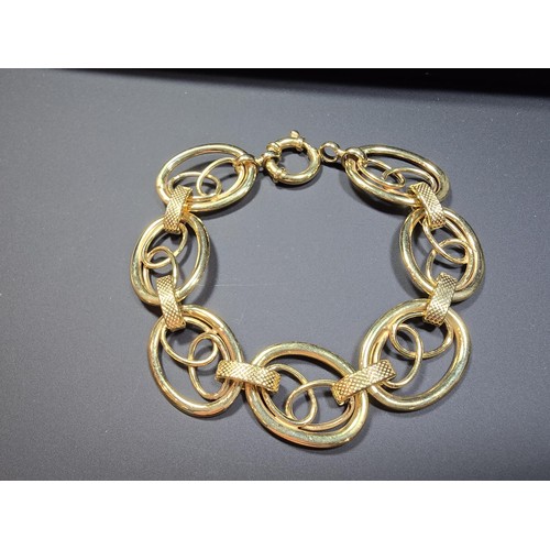 301 - A modern hallmarked 9ct yellow gold bracelet with an unusual multi loop design, in excellent clean c... 