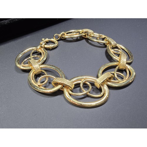 301 - A modern hallmarked 9ct yellow gold bracelet with an unusual multi loop design, in excellent clean c... 