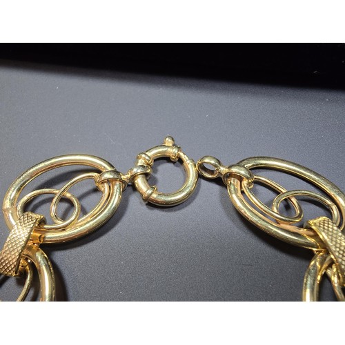 301 - A modern hallmarked 9ct yellow gold bracelet with an unusual multi loop design, in excellent clean c... 