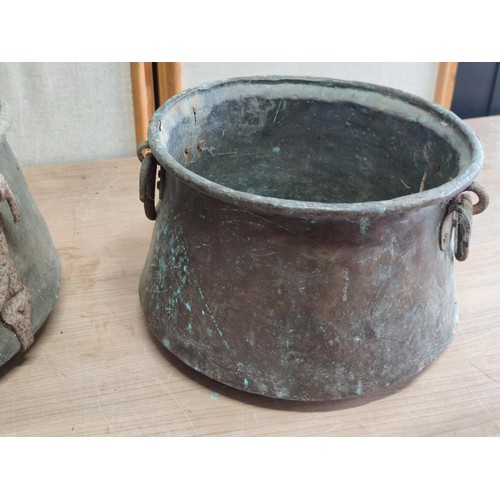 438 - Pair of antique copper pans with wrought iron handles, one pan has holes to the base largest has a h... 