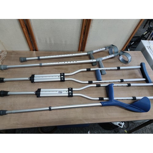 452 - A collection of disability aid items including pair of underarm crutches, 3x arm crutches all are ad... 