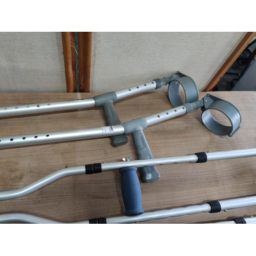 452 - A collection of disability aid items including pair of underarm crutches, 3x arm crutches all are ad... 