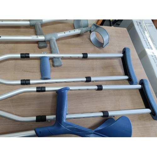 452 - A collection of disability aid items including pair of underarm crutches, 3x arm crutches all are ad... 