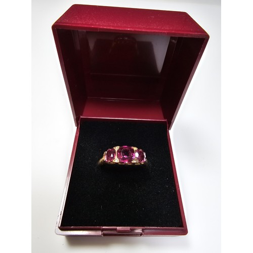 305 - An 18ct yellow gold 3 stone ring inset with 3 large and impressive almandine garnet stones presentin... 