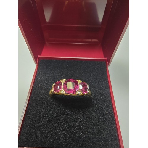 305 - An 18ct yellow gold 3 stone ring inset with 3 large and impressive almandine garnet stones presentin... 