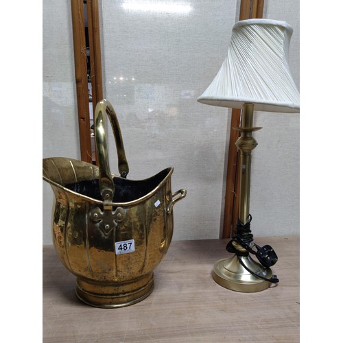 487 - A pair of brass items including a good quality coal scuttle with handle along with a brass lamp with... 