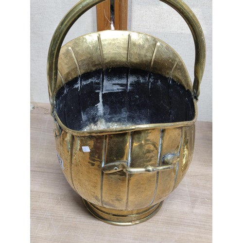 487 - A pair of brass items including a good quality coal scuttle with handle along with a brass lamp with... 