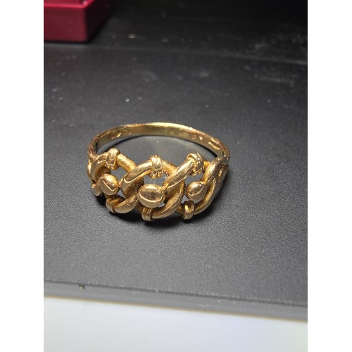 314 - A hallmarked 18ct yellow gold ring with a 3 knot design. In excellent clean condition and boxed ,siz... 