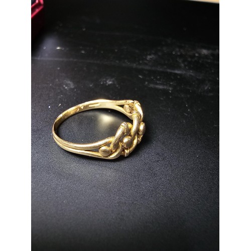 314 - A hallmarked 18ct yellow gold ring with a 3 knot design. In excellent clean condition and boxed ,siz... 