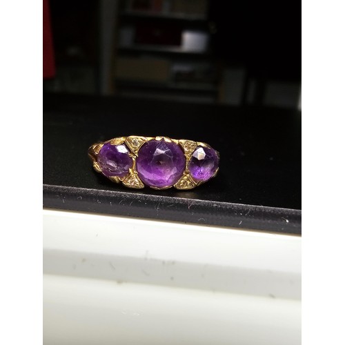 316 - A hallmarked 9ct yellow gold 3 stone ring inset with 3 faceted amethyst stones, in good clean condit... 