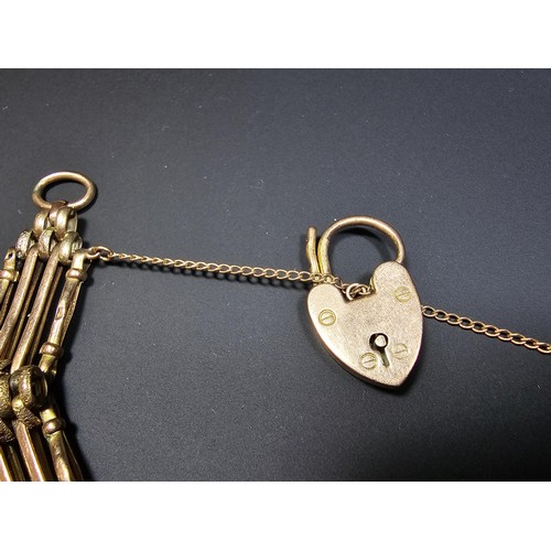 320 - a 9ct yellow gold 4 bar gate bracelet with a 9ct yellow gold padlock charm, in excellent clean condi... 