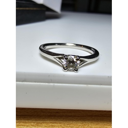 322 - A fine quality 950 platinum diamond solitaire ring inset with a 0.24 ct diamond with a full diamond ... 