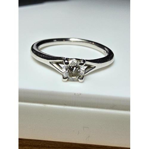 322 - A fine quality 950 platinum diamond solitaire ring inset with a 0.24 ct diamond with a full diamond ... 