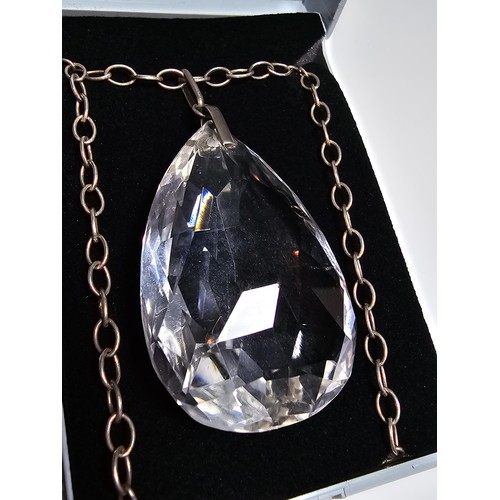 323 - A very large and impressive quarts rock crystal faceted pendant set on a long 24