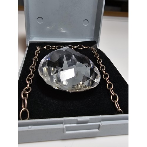 323 - A very large and impressive quarts rock crystal faceted pendant set on a long 24