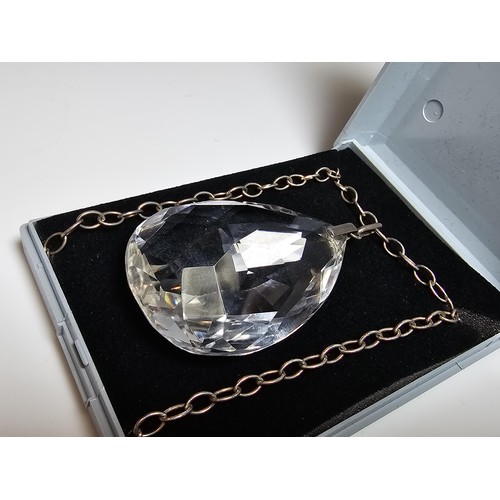 323 - A very large and impressive quarts rock crystal faceted pendant set on a long 24