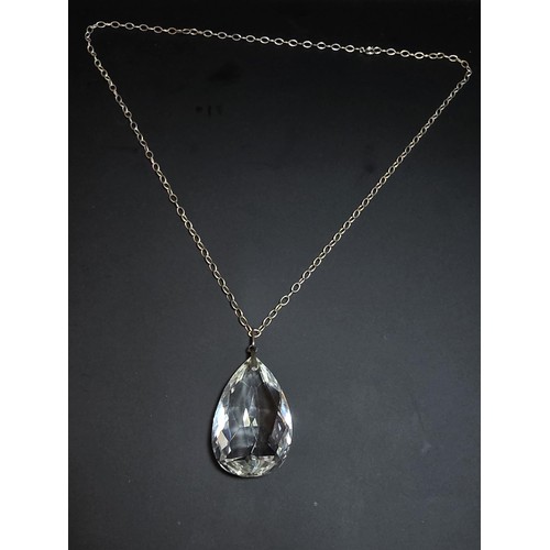 323 - A very large and impressive quarts rock crystal faceted pendant set on a long 24