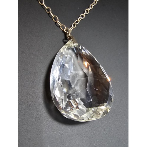 323 - A very large and impressive quarts rock crystal faceted pendant set on a long 24