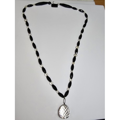 324 - A good crystal necklace to include a large quartz rock crystal faceted pendant with jet and crystal ... 